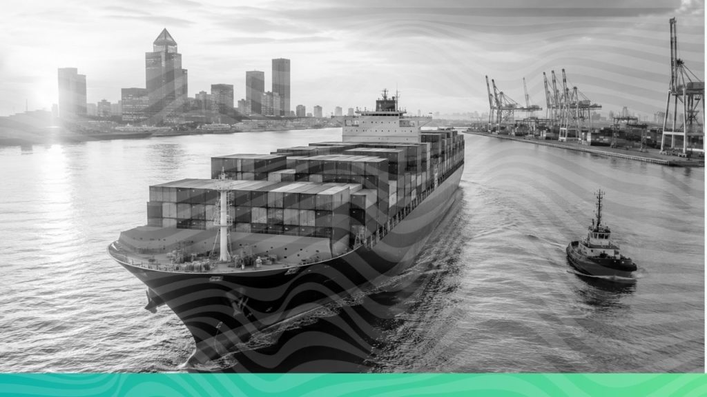 A large container cargo ship navigating green ocean waters near a port representing UK CBAM and global carbon trade compliance.